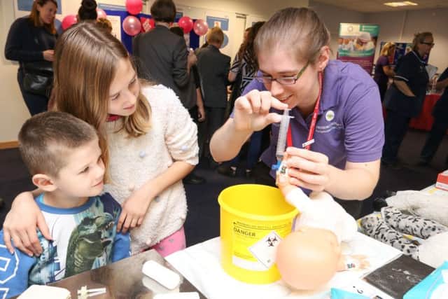 Matthew and Molly Dyson being shown how a cannula works by play specialist Zoe Parton Picture: Habibur Rahman