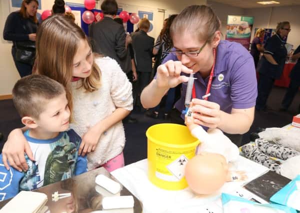 Matthew and Molly Dyson being shown how a cannula works by play specialist Zoe Parton                          Picture: Habibur Rahman