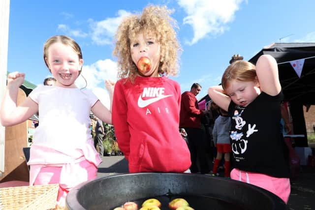 Evie Wedderburn, six,  Jake Crosswell, seven, and Zoe Wedderburn, four, apple bobbing Picture: Habibur Rahman