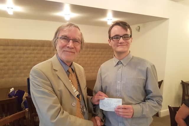 Keiran Mundy being presented with his cheque by Rotary president Simon Mason