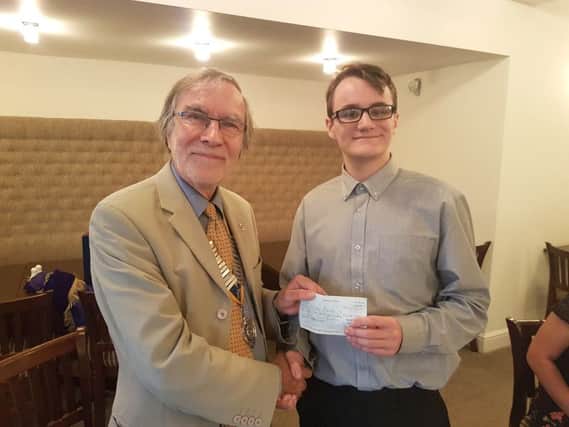 Keiran Mundy being presented with his cheque by Rotary president Simon Mason