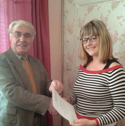 Vice president Raymond Drake presents Lacy-Love Kentwith her commendation