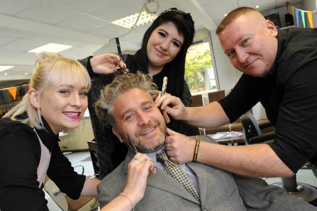 Jamie Martin has his hair and beard trimmed by, from left, Katey Finlayson, Ella Waite and Jacob McFadden Picture: Malcolm Wells (161014-0775)