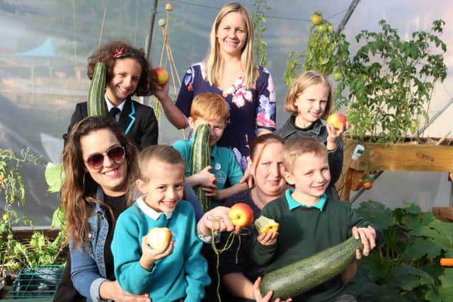 Kiera-Mia Ablett, 12, Rachael Wilson, Maggie Lucas, six, Michelle Garland, Riley Garland, six, Lisa Ablett, Trinity Ablett, nine, and Shaun Ablett, six, in the polytunnel with fresh fruit and vegtables Picture: Habibur Rahman (161458-83)