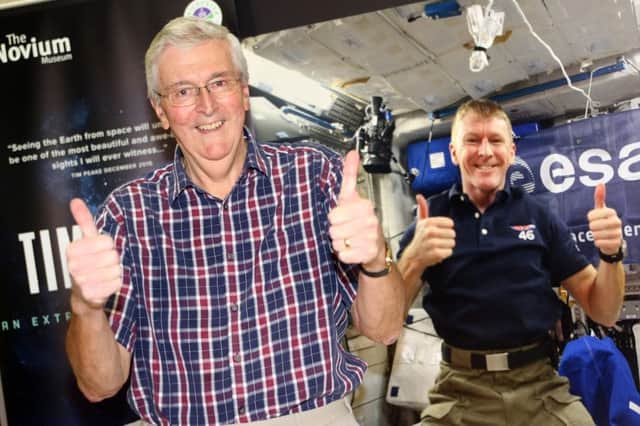 Proud dad Nigel Peake in front of an image of his son, astronaut Maj Tim Peake, behind him      PICTURE Derek Martin