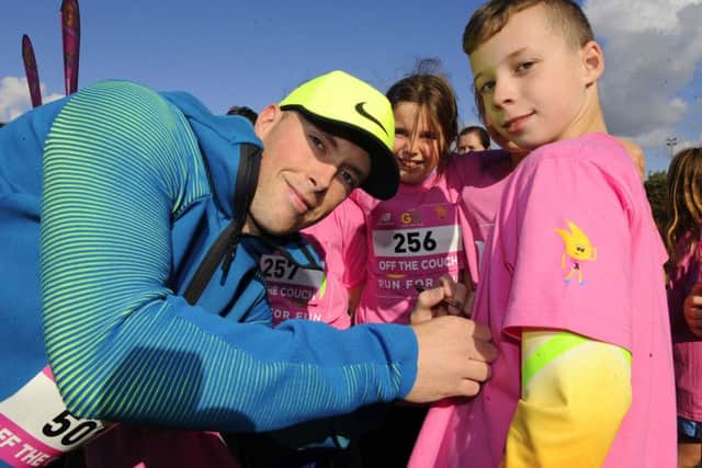 Olympic athlete Richard Kilty signs the T-shirts of children from Purbrook Junior School Picture: Malcolm Wells (161020-1629)