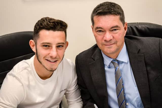 Conor Chaplin signs his new Blues deal in the company of Pompey chief executive Mark Catlin Picture: Colin Farmery