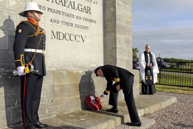 Commander David Johnston lays the wreath at the Nelson monument  Picture: Malcolm Wells (161021-1880)