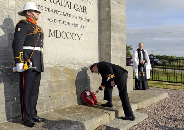 Commander David Johnston lays the wreath at the Nelson monument Picture: Malcolm Wells (161021-1880)