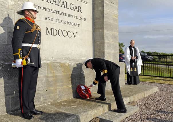 Commander David Johnston lays the wreath at the Nelson monument  Picture: Malcolm Wells (161021-1880)
