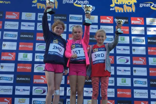 Girls' winners of the Mini Great South Run. Pictured left to right are, Emily Channon, second, Florence East, winner, and Finney Coomber, right.