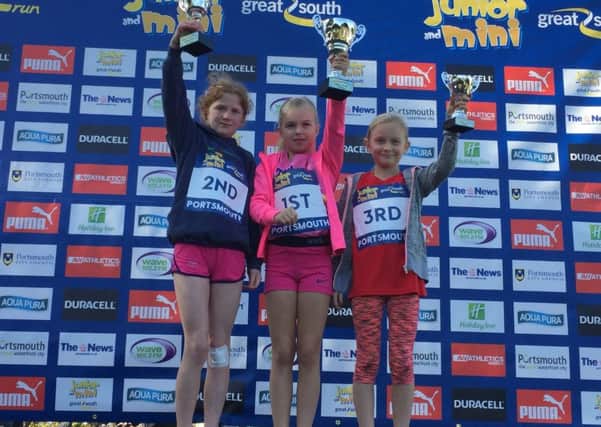 Girls' winners of the Mini Great South Run. Pictured left to right are, Emily Channon, second, Florence East, winner, and Finney Coomber, right.