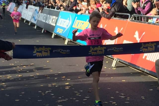 Jack Potter, eight, of Whiteley, crosses the finishing line in the opening wave of the Mini Great South Run