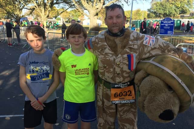 Royal Marine veteran Tony Ryan will be running the Great South Run dressed as a bear. He is pictured with son Oliver Ryan, 14, centre, and Matthew Elson, 14, left.