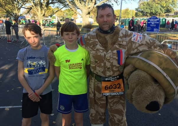 Royal Marine veteran Tony Ryan will be running the Great South Run dressed as a bear. He is pictured with son Oliver Ryan, 14, centre, and Matthew Elson, 14, left.