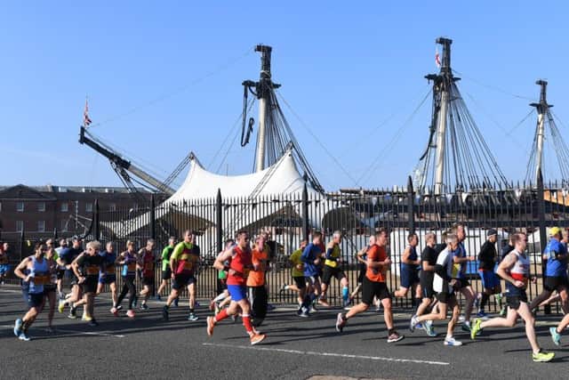 Passing HMS Victory during the 10-mile run 
Picture: Paul Jacobs/pictureexclusive.com