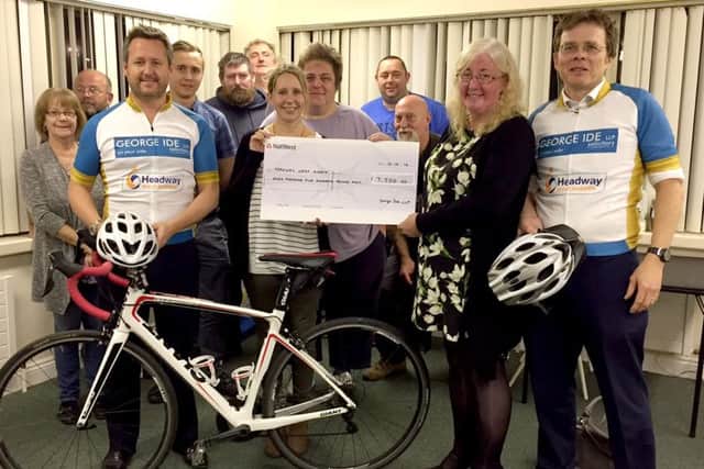 George Ide solicitors present their cheque for £7,500 to Headway West Sussex