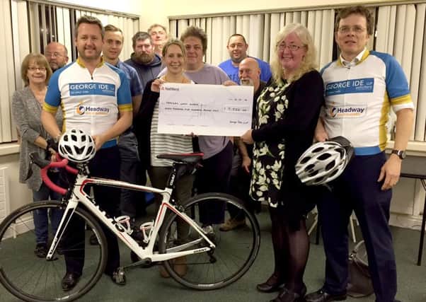 George Ide solicitors present their cheque for Â£7,500 to Headway West Sussex