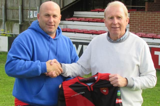 Petersfield director of football Gary Lines welcomes John Robson, right, to the club