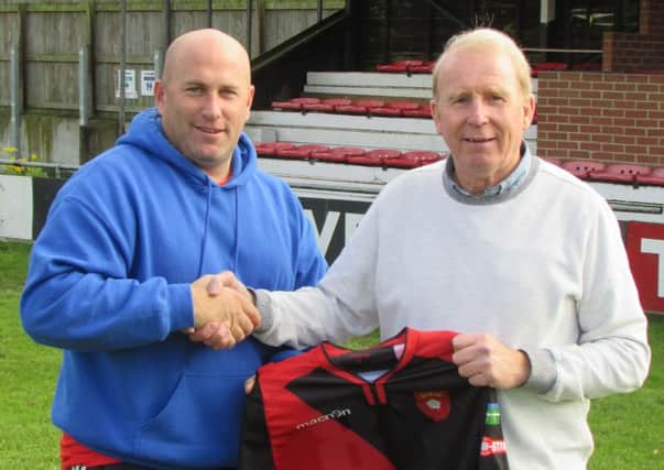 Petersfield director of football Gary Lines welcomes John Robson, right, to the club