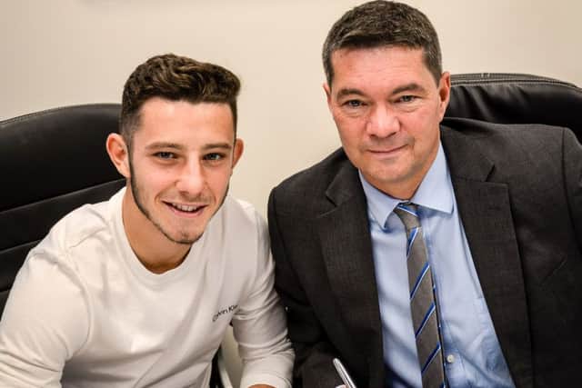 Conor Chaplin signs his new Pompey deal in the presence of chief executive Mark Catlin Picture: Colin Farmery