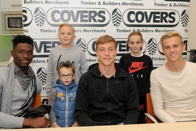 From left, Pompey players Amine Linganzi, Tom Davies and Alex Bass with Lennon Keil, nine, and friends Charlie Davis, four, and Toby Davis, nine, from North End.
Picture: Sarah Standing (161471-8970)