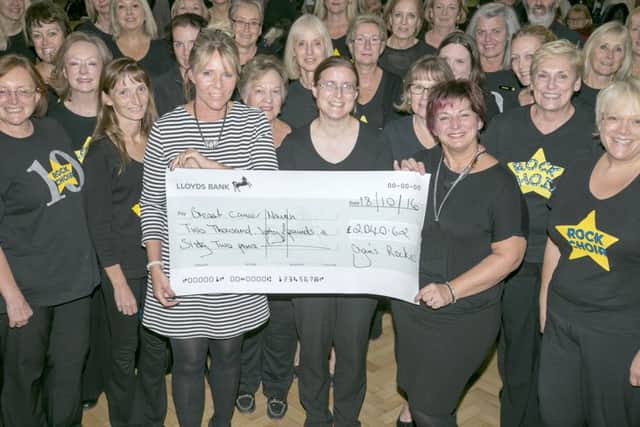 Rock Choir, presenting a cheque to Breast Cancer Haven, Wesses, following a performance in Hedge End, Fareham.