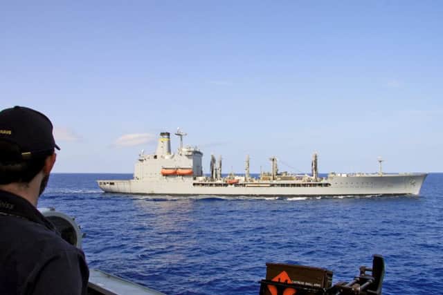 A sailor from HMS Diamond observes the American USNS Big Horn replenishment ship in the Mediterranean