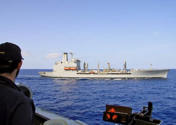 A sailor from HMS Diamond observes the American USNS Big Horn replenishment ship in the Mediterranean