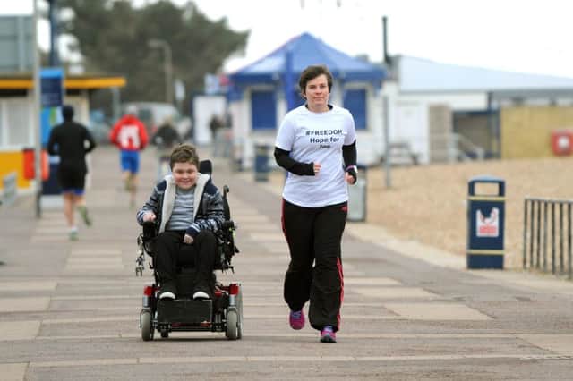 Joe Rush, 14, with Janet Dickso, who is running hundreds of miles to fundraise for him