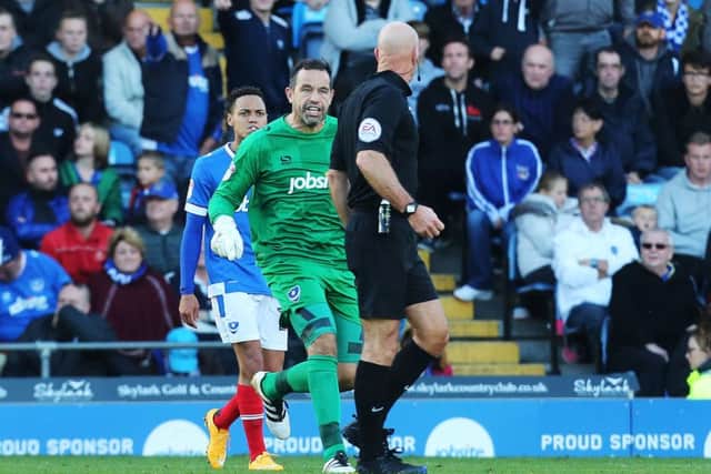 Pompey keeper David Forde confronts referee Nigel Miller. Picture: Joe Pepler