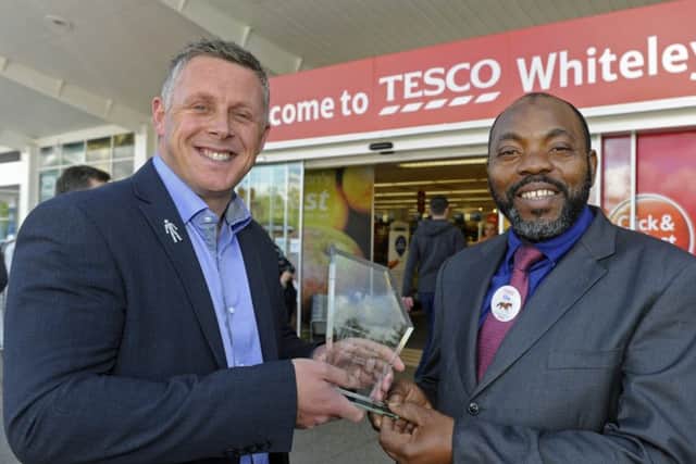 Darren Gooding of Whiteley Village awards security guard Ola Ayeni with the News Customer Service Accolade
Picture: Ian Hargreaves (161264-1)
