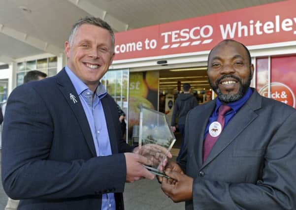Darren Gooding of Whiteley Village awards security guard Ola Ayeni with the News Customer Service Accolade 
Picture: Ian Hargreaves (161264-1)