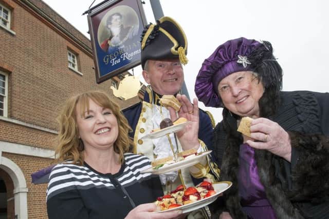 Roseann McKechnie, owner of the Georgian Tea Rooms in Portsmouth Historic Dockyard, serves sandwiches and cake to Roger and Barbara Glanceford, who volunteer as guides at the National Museum of the Royal Navy, at the relaunch of the Georgian tea rooms
in May last year Picture: Steve Reid/Blitz Photography