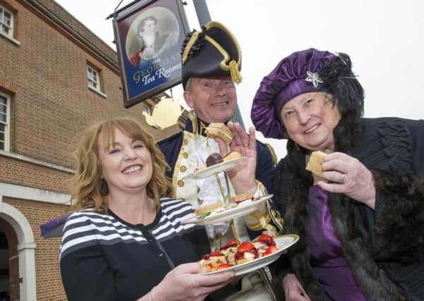 Roseann McKechnie, owner of the Georgian Tea Rooms in Portsmouth Historic Dockyard, serves sandwiches and cake to Roger and Barbara Glanceford, who volunteer as guides at the National Museum of the Royal Navy, at the relaunch of the Georgian tea rooms 

in May last year Picture: Steve Reid/Blitz Photography
