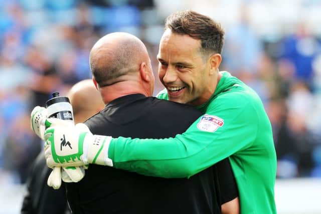 David Forde and Paul Cook celebrate victory over Colchester. Picture: Joe Pepler