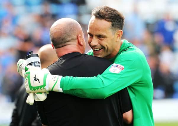 David Forde and Paul Cook celebrate victory over Colchester. Picture: Joe Pepler