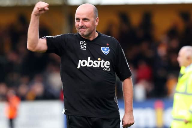 Paul Cook salutes the travelling fans after 10-man Pompey claimed a gutsy 1-0 win at Cambridge United today   Picture: Joe Pepler