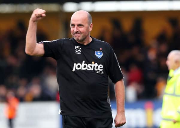 Paul Cook salutes the travelling fans after 10-man Pompey claimed a gutsy 1-0 win at Cambridge United today   Picture: Joe Pepler