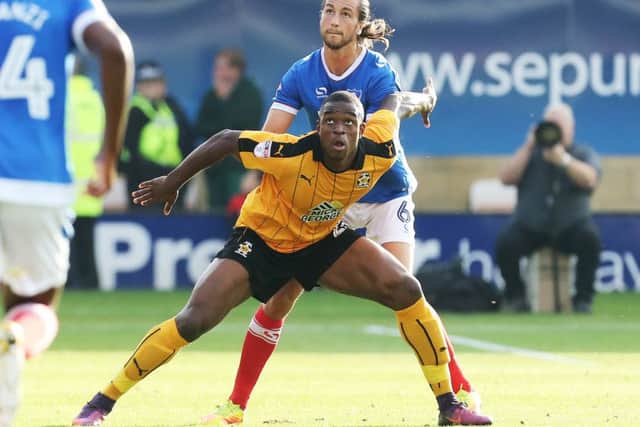 Christian Burgess keeps a close eye on Cambridge striker Uche Ikpeazu Picture: Joe Pepler