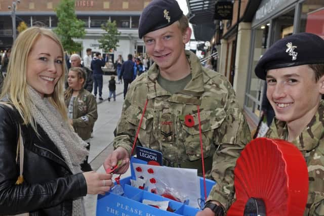 Lisa Sloane from Gosport buys a poppy from army cadets Cpl Josh Reynolds, left, and L/Cpl Matthew O'Brien Picture: Ian Hargreaves (161271-2)