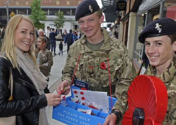 Lisa Sloane from Gosport buys a poppy from army cadets Cpl Josh Reynolds, left, and L/Cpl Matthew O'Brien 
Picture: Ian Hargreaves (161271-2)