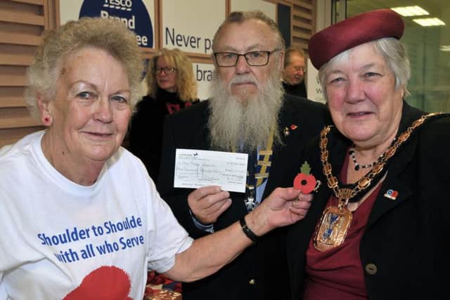 Havant mayor Cllr Faith Ponsonby at the launch of the Royal British Legion Poppy Day at the town's Tesco Extra, with organiser Olive Rush and branch chairman Dave Argue, who presented a cheque for Â£1,000 
Picture: Mick Young
 (161178-03)