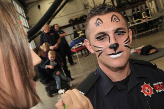 Firefighter Brett Baker gets his face painted Picture: Mick Young (161179-02)