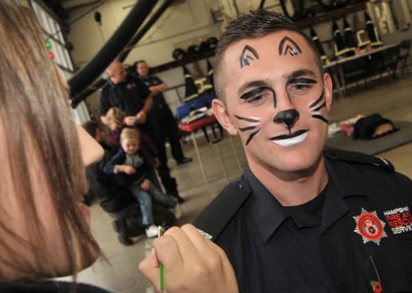 Firefighter Brett Baker gets his face painted Picture: Mick Young (161179-02)