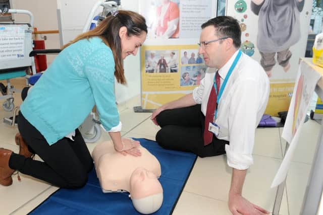 Sarah Conway from Unison learning how to give CPR with Carl Davies, resuscitation officer at Queen Alexandra Hospital Picture: Sarah Standing (161419-4984)