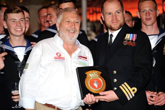 Alan Priddy with sailors from HMS Diamond and the shield