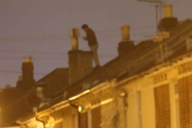 Ben MccReadie on the roof in Widley Road, Stamshaw, on Sunday morning. Picture: Uknip