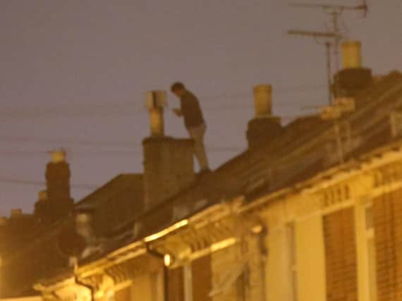 Ben MccReadie on the roof in Widley Road, Stamshaw, on Sunday morning. Picture: Uknip
