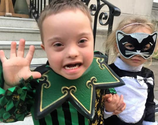 Harry and Ruby Archer dressed as a jester and a cat at the Portsmouth Down Syndrome Association Halloween party